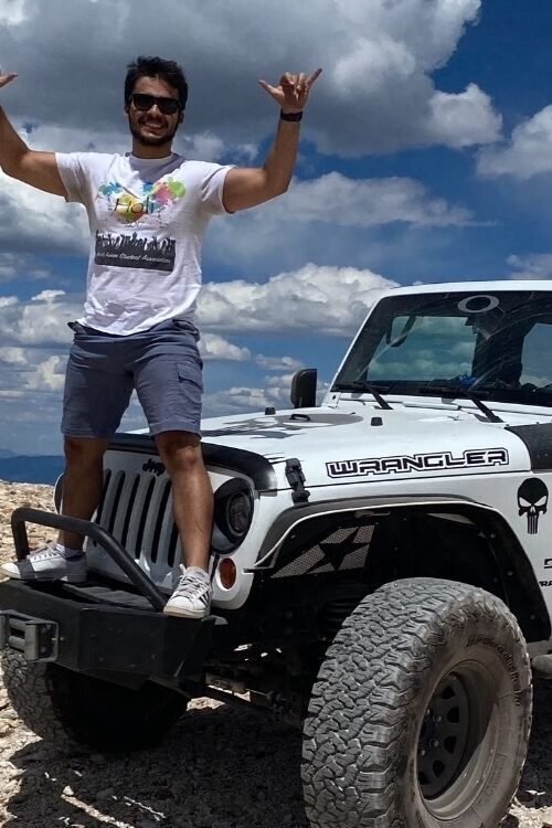 the creator of Diary of Money standing on his Jeep bumper